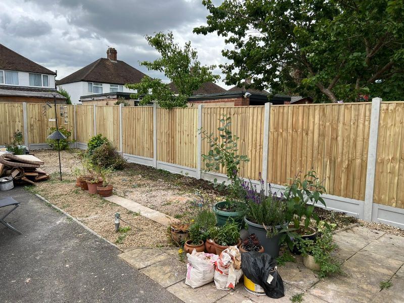 Concrete fence posts and fence in garden