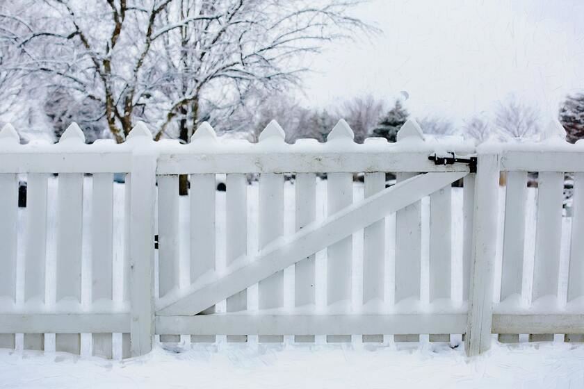 Timber fencing and gate amidst snow