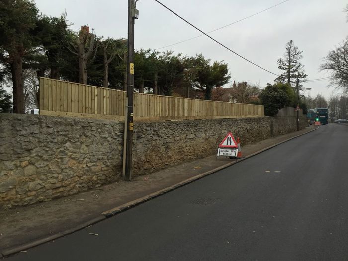 Close board fencing above wall